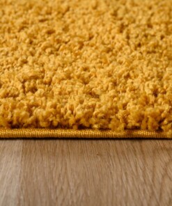 Tapis ovale poils longs - Shaggy Trend jaune moutarde - close up zijkant, thumbnail